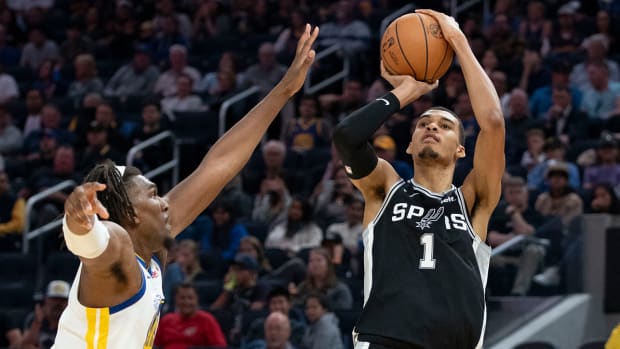 Spurs’ Victor Wembanyama takes a jump shot vs. the Warriors in an NBA preseason game.